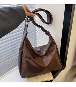 Detail view of large dark brown PU leather hobo bag with adjustable strap and front pocket