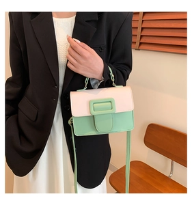 Detail view of stylish color-block PU leather crossbody bag with mint green square buckle