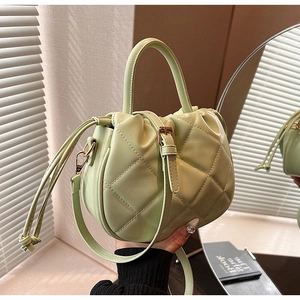 Mint green quilted PU leather handbag with drawstring closure and crossbody strap