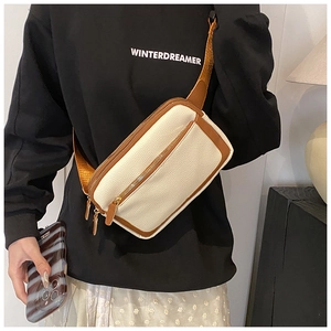 Detail of the high-quality lychee texture synthetic leather on a cream crossbody bag