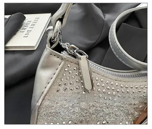 Detail of a smooth silver metal zipper on a bag embellished with sparkling rhinestones