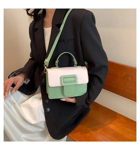 Detail showing mint green and pink patchwork crossbody bag with gold metal buckle