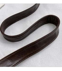 Close-up of dark brown soft leather shoulder strap with fine stitching details