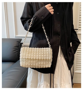 Exquisite white pearl woven handbag with elegant beaded strap and vintage aesthetic design
