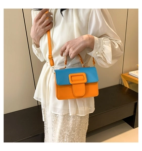 Chic blue and orange contrast PU leather crossbody bag worn by a model in a white shirt