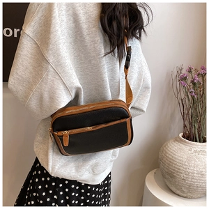 Detail view of the multi-layer zipper compartments and mixed color PU leather finish