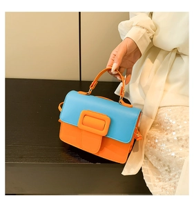 Detail of blue and orange contrast PU leather crossbody bag with decorative square buckle