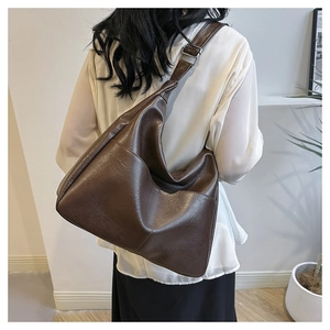 Deep brown oversized PU leather tote bag with wide strap and silver buckle detail