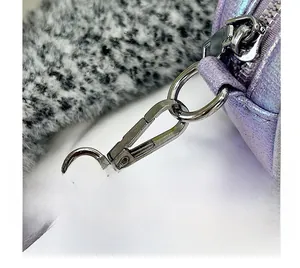 Detail of silver metallic hook and iridescent purple faux leather strap on handbag