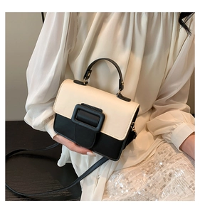 Close-up of contrast color PU leather crossbody bag with oversized black square buckle
