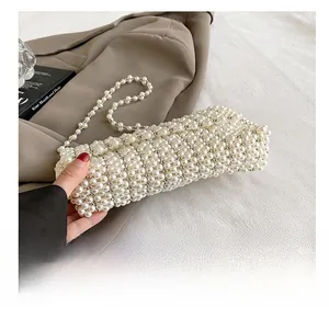 Detailed view of handcrafted white pearl woven handbag with elegant beaded chain strap