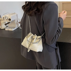 Elegant white drawstring bucket bag with silver chain and pearl charm detail