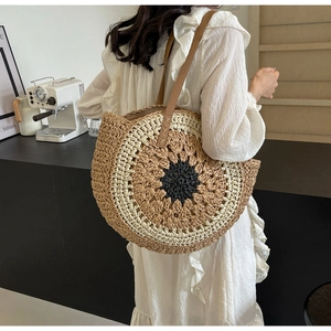 Detailed macro view of multi-color circular woven straw bag with premium leather straps
