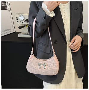 Detail of pink PU hobo bag with sparkling rhinestones and silver bow buckle accessory
