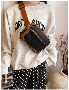 Detailed view of black litchi pattern PU leather crossbody bag with brown trim and strap