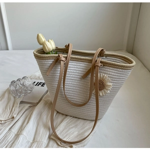 White woven tote bag with a 3D sunflower accent and tan leather straps for summer fashion