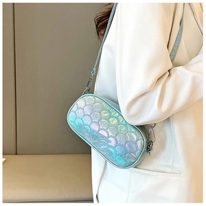 Detail of light blue holographic fish scale pattern bag with metallic silver hooks