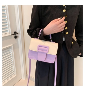 Detail view of stylish color-block PU leather crossbody bag with square buckle and handle