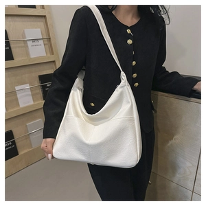 Close-up of white lychee pattern PU leather shoulder bag with stylish V-shaped stitching