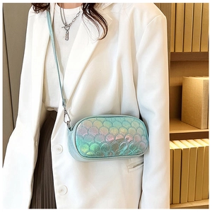 Chic iridescent mint green crossbody bag with fish scale texture on a model