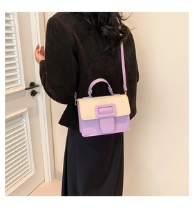 Detailed view of the lavender and cream PU leather crossbody bag worn by a model