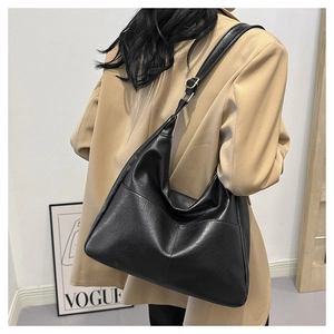 Detail of black large capacity hobo bag with V-shaped stitching and adjustable strap