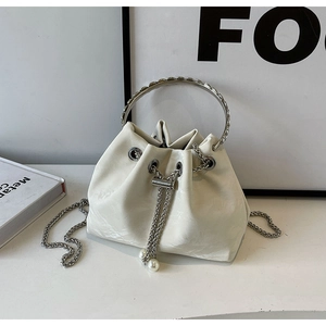 Chic beige velvet bucket bag with silver ring handle and pearl chain drawstring closure