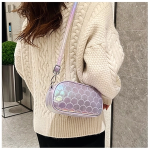 Detail view of purple laser shell embossed PU leather crossbody bag on a model
