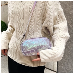 Detail of purple holographic PU leather crossbody bag with fish scale texture on sweater