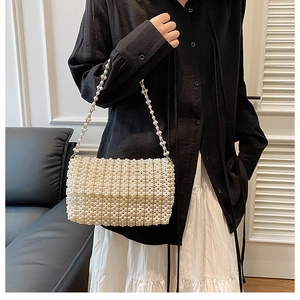 Elegant rectangular shoulder bag covered in cream pearls with a matching beaded chain strap