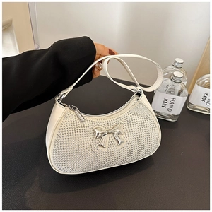White faux leather crescent bag with silver rhinestones and a metal bow detail