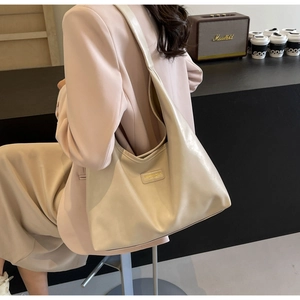 Detailed shot of cream PU leather shoulder bag showing large capacity and soft texture