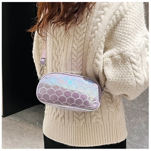 Detail view of purple mermaid scale PU leather crossbody bag on a knit sweater background