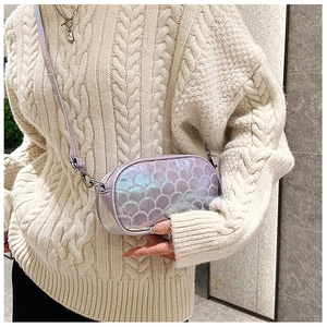 Detail of laser iridescent PU crossbody bag featuring stitched fish scale pattern texture