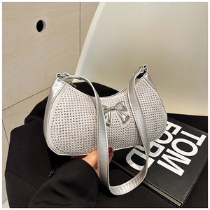 Sparkly silver rhinestone shoulder bag with metal bow decoration and metallic strap