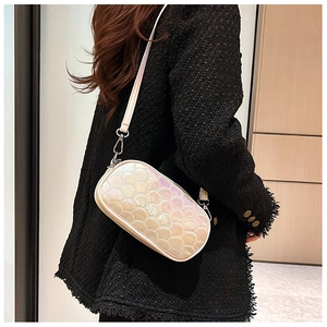Detail of holographic PU leather shoulder bag featuring quilted fish-scale texture pattern