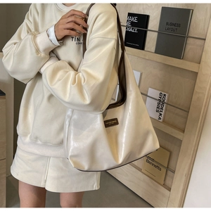 Chic cream PU leather tote bag with brown straps styled with a casual outfit