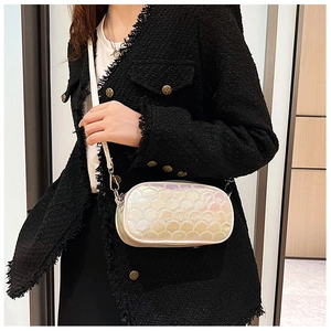 Detail view of oval crossbody bag with holographic fish scale embossed pattern