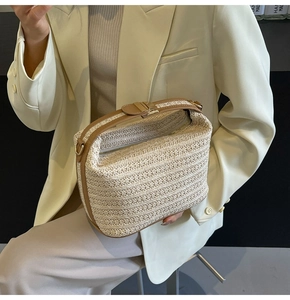 Dettaglio della borsa di tendenza in paglia con fibre beige e finiture in pelle marrone