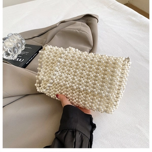 Elegant ivory pearl beaded handbag for women featuring a handmade rectangular woven design