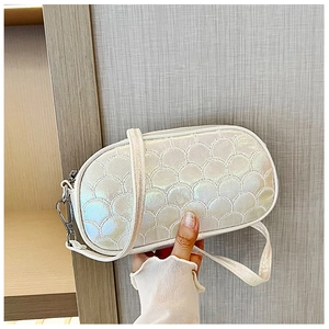 Iridescent white crossbody bag with scalloped quilting and metallic finish strap