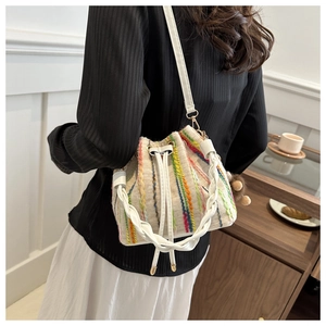 Detail of multi-color striped knitted bucket bag with white leather drawstring closure