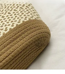 Close-up of woven handbag textures with two-tone beige and brown stitching
