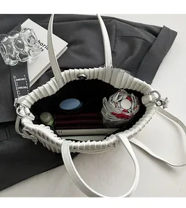 Interior view of white quilted PU crossbody bag showing large capacity for daily items