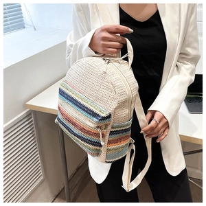 Detail of the colorful striped woven texture and zip pocket on this crossbody bag