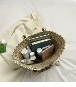 Detail of spacious woven tote with bamboo handles showing laptop and makeup storage