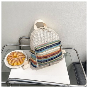 Minimalist woven crossbody bag featuring colorful stripes and ivory herringbone texture