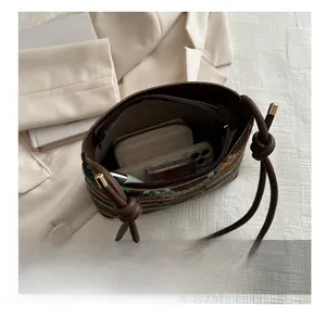 Top view of striped woven bag interior showing space for wallet, phone and cosmetics