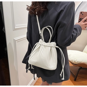 Detailed back view of a white pleated PU leather crossbody bag with drawstring closure