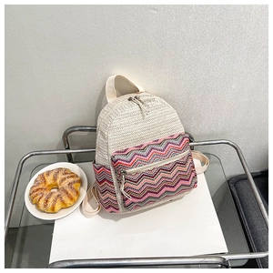 Minimalist woven crossbody bag with bohemian patterned front pocket and top handle